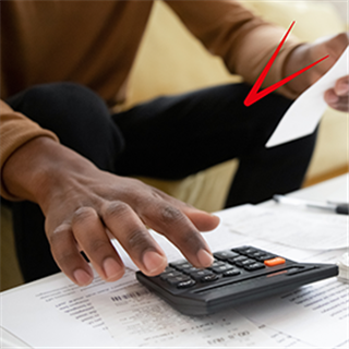 Man working on a calculator